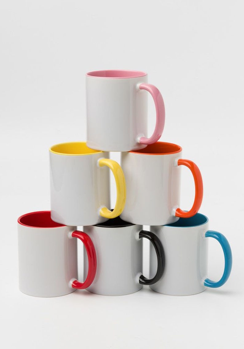 May include: Six white ceramic mugs with colored rims and handles. The mugs are stacked in a pyramid shape. The colors of the rims and handles are pink, yellow, orange, red, black, and blue.