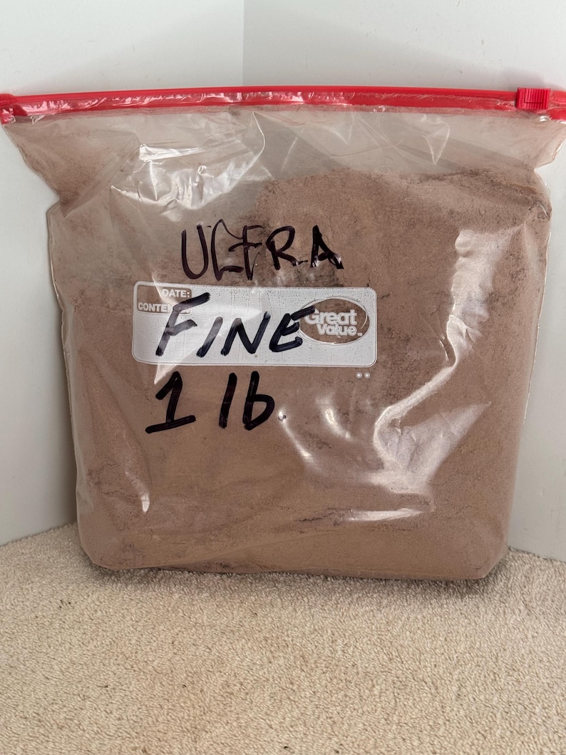 May include: A clear plastic bag filled with brown powder labeled "ULTRA FINE 1 LB" with a "Great Value" sticker.