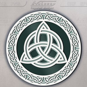 May include: A white Celtic knot design with a green center, in a circular shape. The knot is intricate and detailed, with a three-leaf clover design in the center.