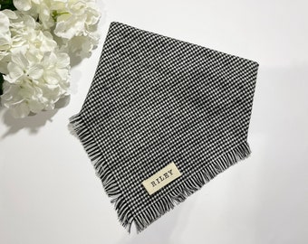 May include: Black and white gingham dog bandana with frayed edges and a brown tag that says "RILEY".