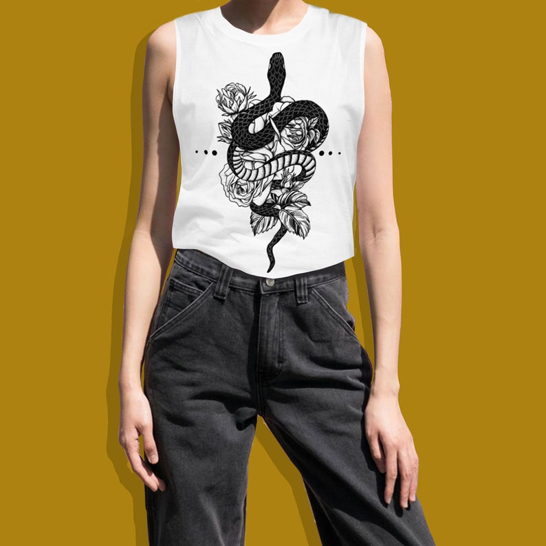 May include: White sleeveless tank top featuring a black and white graphic print of a snake entwined with roses.