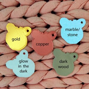 May include: Five different colored plastic animal shapes with text on each. The shapes are gold, copper, light blue, dark blue, and dark green. The text on the shapes reads "gold", "copper", "marble/stone", "glow in the dark", and "dark wood".