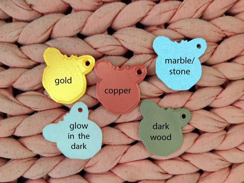 May include: Five different colored plastic animal shapes with text on each. The shapes are gold, copper, light blue, dark blue, and dark green. The text on the shapes reads "gold", "copper", "marble/stone", "glow in the dark", and "dark wood".