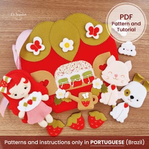 May include: A felt craft kit featuring a red strawberry-shaped house with green leaves, a doll with red hair, a white cat, a white dog, and small strawberry cutouts. The text reads PDF Pattern and Tutorial and Patterns and instructions only in PORTUGUESE (Brazil).