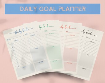 May include: A stack of daily goal planners with a light pink background. Each planner has a different colored header: blue, green, and red. The text "DAILY GOAL PLANNER" is at the top. Each planner has sections for scheduling, to-do lists, notes, and self-care.