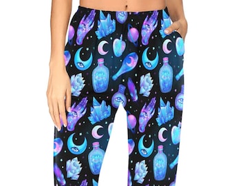 May include: Black sweatpants with a repeating pattern of blue and purple crystals, moons, stars, hands, and bottles.