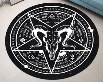 May include: Black and white round rug with a pentagram design and a skull with horns in the center. The pentagram is surrounded by a circle of stars and text.