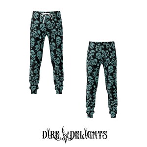 May include: Two pairs of black sweatpants featuring a teal dragon design. The trousers have a drawstring waist and cuffed ankles. The logo "Dire Delights" is displayed at the bottom of the image.