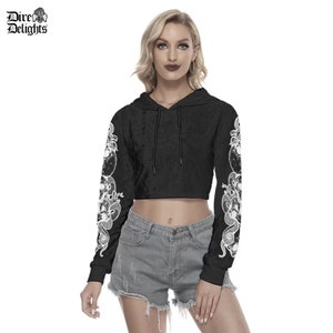 May include: Black cropped hoodie with long sleeves featuring a white snake design. The hoodie has a drawstring hood.