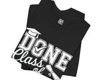 May include: Black t-shirt with the words "Done Class of" and a graduation cap and diploma graphic in white. The shirt is folded and has a QR code on the upper right side.