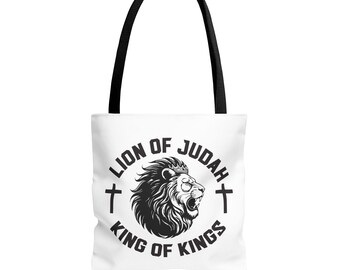 May include: White tote bag with black handles featuring a black and white lion's head design. The text "LION OF JUDAH KING OF KINGS" is printed around the lion's head, with crosses on either side.