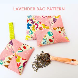 May include: Pink and floral patterned lavender bags with a copper spoon and dried lavender buds. The bags are square-shaped with a pinwheel design. The text "LAVENDER BAG PATTERN" is at the top.