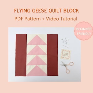May include: A quilt block with a "Flying Geese" pattern, featuring pink and cream triangles, and burgundy side panels. The image includes sewing pins, a small card, and scissors. Text reads "Flying Geese Quilt Block PDF Pattern + Video Tutorial" and "Beginner Friendly."