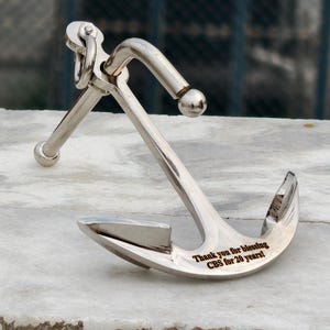 Engraved anchor paperweight detail showing custom message, luxury office decor piece