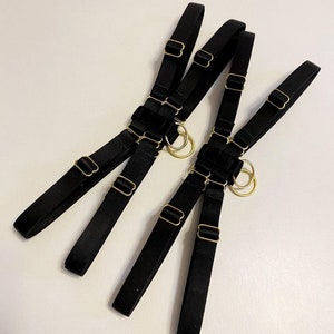 Pair of adjustable black thigh garters, also available in burgundy, beige, red and milky white, white.