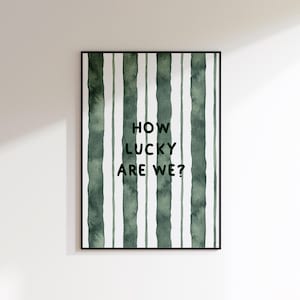 May include: A green and white striped print with the text "How lucky are we?" in black.