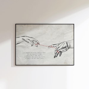 Könnte beinhalten: Schwarz gerahmter Kunstdruck mit zwei Händen, die sich nach einem roten Faden ausstrecken. Die Illustration ist eine Strichzeichnung auf einem strukturierten, cremefarbenen Hintergrund. Der Text unten lautet: "Ein unsichtbarer roter Faden verbindet diejenigen, die sich treffen sollen..."