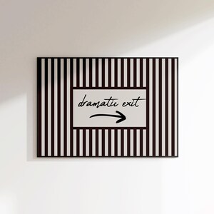 May include: A rectangular sign with a black and white striped border. The center features a white rectangle with the words "dramatic exit" and an arrow pointing right.