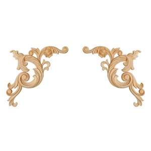 May include: A pair of ornate, wooden, decorative corner pieces with a light brown finish. The pieces are carved with intricate floral designs.