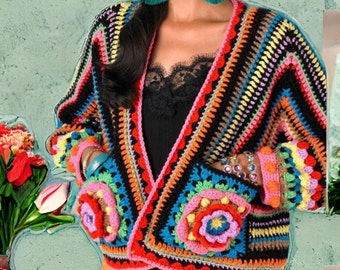 May include: A colorful crochet cardigan with a black background and floral accents. The cardigan has a V-neck and long sleeves. The sleeves and pockets have colorful crocheted flowers.