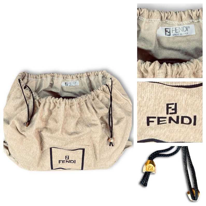 May include: Beige Fendi dust bag with a drawstring closure. The bag features the Fendi logo in a black rectangle on the front. The drawstring is black with gold-colored metal tips. The bag is made of a soft, textured fabric.