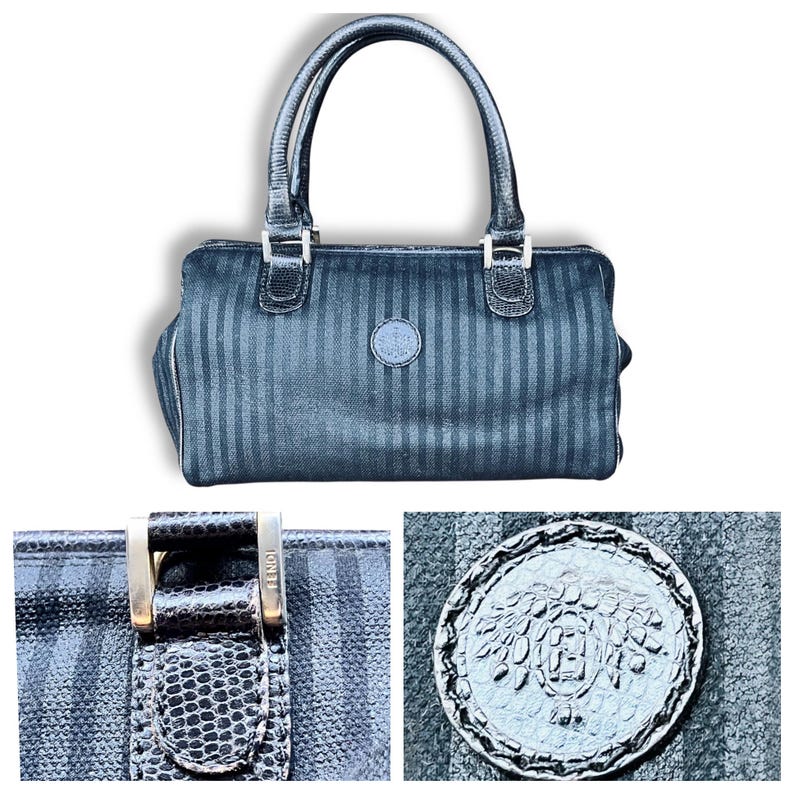 May include: Black handbag with vertical stripe pattern, featuring two handles and silver-tone hardware. The bag has a circular emblem on the front and a zipper closure. The bag is a classic style.
