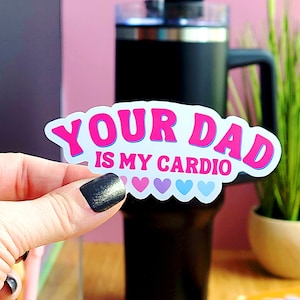 May include: A white sticker with pink and blue lettering that reads "Your Dad is My Cardio" with five pink and blue hearts below the text.