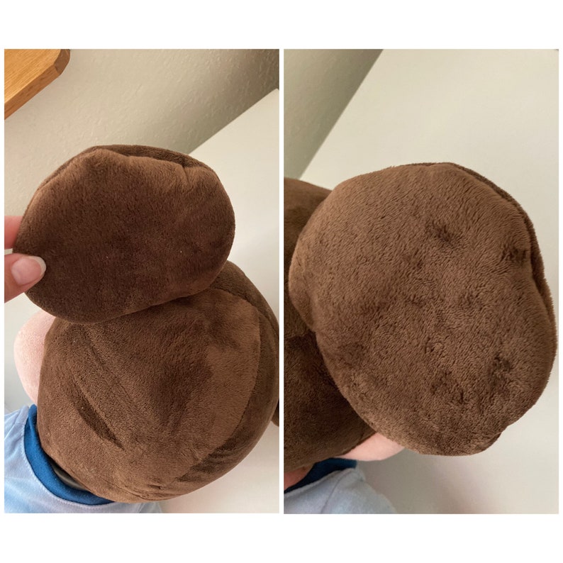 May include: A brown plush toy with a brown hair bun on top of its head. The toy is wearing a blue shirt.
