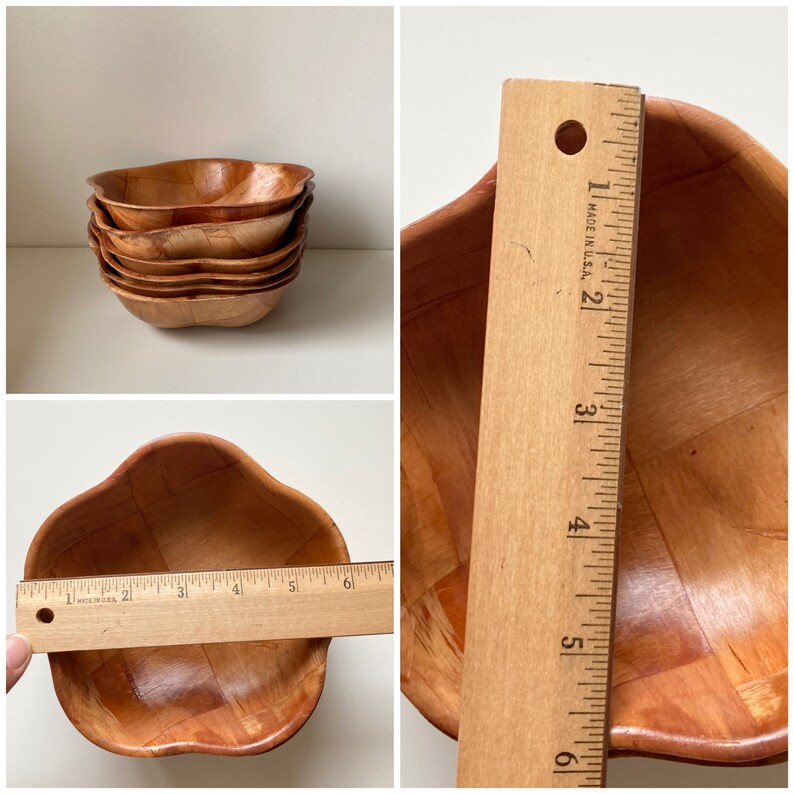 May include: Set of four wooden bowls with a woven pattern. The bowls are stacked on top of each other and are a light brown color.