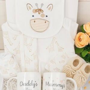 May include: A set of three ceramic mugs with a speckled, matte finish in cream, light grey, and dark grey. Each mug has a simple, minimalist design, suitable for coffee or tea.
