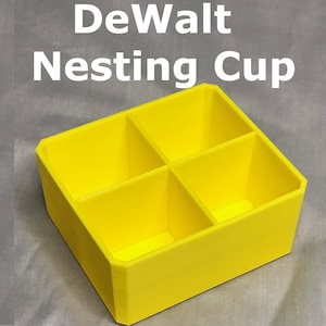 May include: A yellow plastic nesting cup with four compartments. DeWalt is written in white letters above the cup.