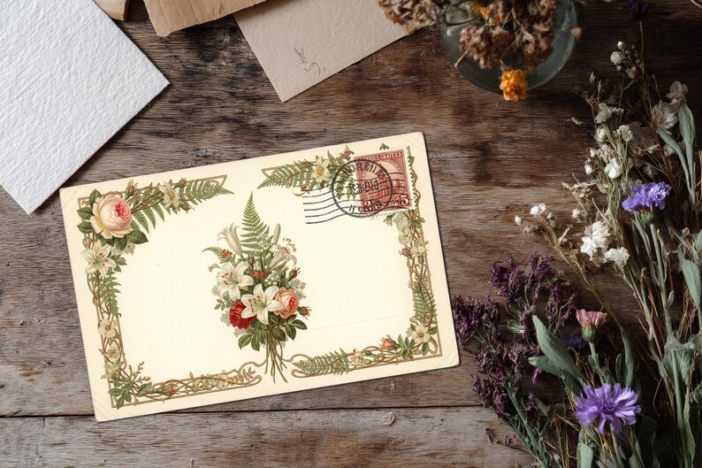 May include: Vintage postcard with floral illustrations, including roses and lilies, and a postage stamp. The postcard is cream-colored with a decorative border and a bouquet of flowers in the center. Dried flowers and paper scraps are on a wooden surface.