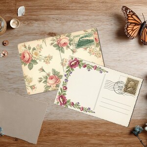 May include: Two vintage postcards with floral designs and postage stamps rest on a wooden surface. A monarch butterfly, dried flowers, and small jars with contents are also present. The postcards feature roses and other flowers.