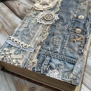 May include: A handmade journal with a denim cover decorated with lace, buttons, and other embellishments. The journal has a rustic, vintage aesthetic.