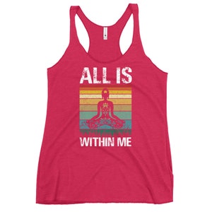 May include: A red tank top with a vintage-style graphic that says "All is within me". The graphic features a person in a yoga pose with a colorful mandala design.