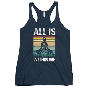 May include: A navy blue tank top with a vintage-style graphic of a meditating figure with the text "ALL IS WITHIN ME".