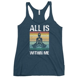 May include: A navy blue tank top with a vintage-style graphic of a person meditating with the text "ALL IS WITHIN ME".
