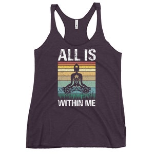 May include: Purple tank top with a vintage-style graphic of a person meditating with the text "ALL IS WITHIN ME".