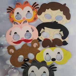 May include: Set of seven felt character masks with eye holes. The masks feature a variety of cartoon characters, including a cat, a bear, a girl, and a boy. The masks are all in different colors and have different facial expressions.