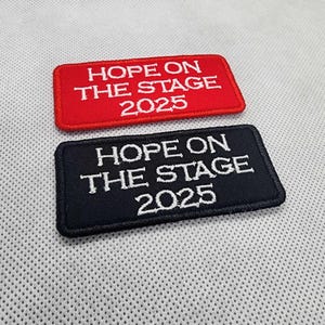 May include: Two embroidered patches, one red and one black, with white text that reads "HOPE ON THE STAGE 2025".