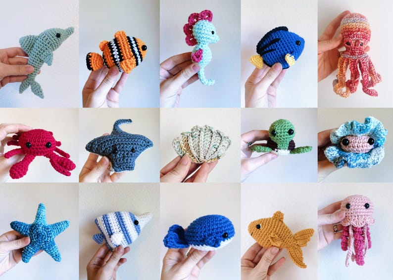May include: A collection of crocheted sea creatures, including a dolphin, a clownfish, a seahorse, a blue fish, an octopus, a crab, a stingray, a seashell, a turtle, a clam, a starfish, a fish with stripes, a whale, a goldfish, and a jellyfish.