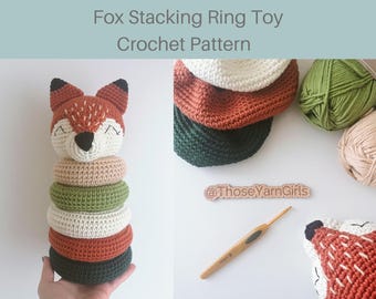 May include: A handmade crochet fox stacking ring toy. The fox head is orange and white, with black accents. The rings are in shades of green, beige, white, and orange. The text "Fox Stacking Ring Toy Crochet Pattern" is at the top.