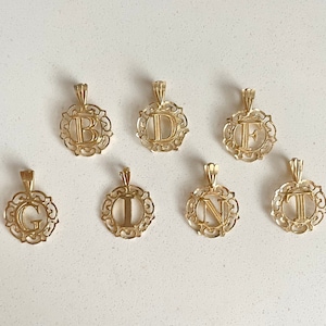 May include: Seven gold-coloured pendants with ornate frames, each featuring a different letter of the alphabet: B, D, E, G, I, N, and T.