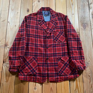 May include: A long-sleeve button-up jacket featuring a red and navy blue plaid pattern. The jacket includes a notched collar, one chest pocket, and two large lower patch pockets. The interior neck label displays the Pendleton brand name.