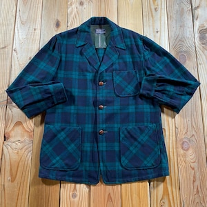 May include: A long-sleeved button-up jacket featuring a dark navy blue and forest green plaid pattern. The garment includes a notched collar, three brown buttons down the front, one chest pocket on the left side, and two larger pockets at the waist.