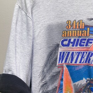 May include: Gray t-shirt with a graphic print of a boat racing on water with flames and the text "34th annual Chief Winter Nationals".
