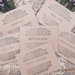 May include: Six kraft paper cards with floral designs and different messages. The messages are "Thank You", "With Love", "Get Well Soon", "Happy Birthday", "Congratulations", and "Good Luck".