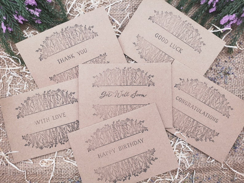 May include: Six kraft paper cards with floral designs and different messages. The messages are "Thank You", "With Love", "Get Well Soon", "Happy Birthday", "Congratulations", and "Good Luck".
