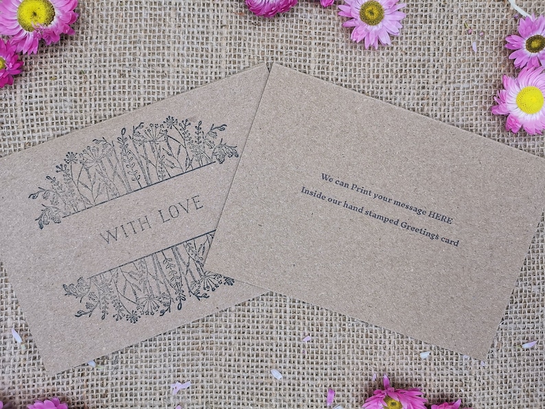 May include: A brown kraft card with a floral design and the text "With Love" printed on the front. The back of the card has the text "We can Print your message HERE Inside our hand stamped Greeting's card".