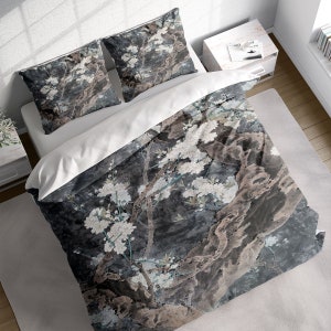 May include: A duvet cover with a grey and white floral pattern. The pattern features a large tree branch with white blossoms and a dark grey background.